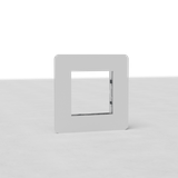 Single 45mm EU paintable switch plate, square white frame, on light surface.