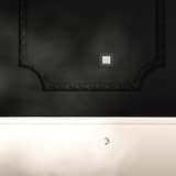 Single Schuko Type F Power Module, round, paintable white socket on a light wall with molding.