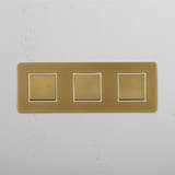Smooth Operation with Triple Rocker Switch in Antique Brass White Design on White Background