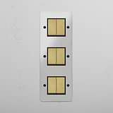 Six-Position Vertical Triple Rocker Switch in Clear Antique Brass Black - Advanced Light Control Accessory on White Background
