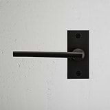 Clayton Short Plate Sprung Door Handle Bronze Finish on White Background right Facing Front View