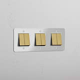 Six-Position Triple Rocker Switch in Clear Antique Brass White - Comprehensive Light Management Accessory