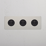Triple 3x French Power Module Round in Polished Nickel Black finish with three black sockets on a white wall.