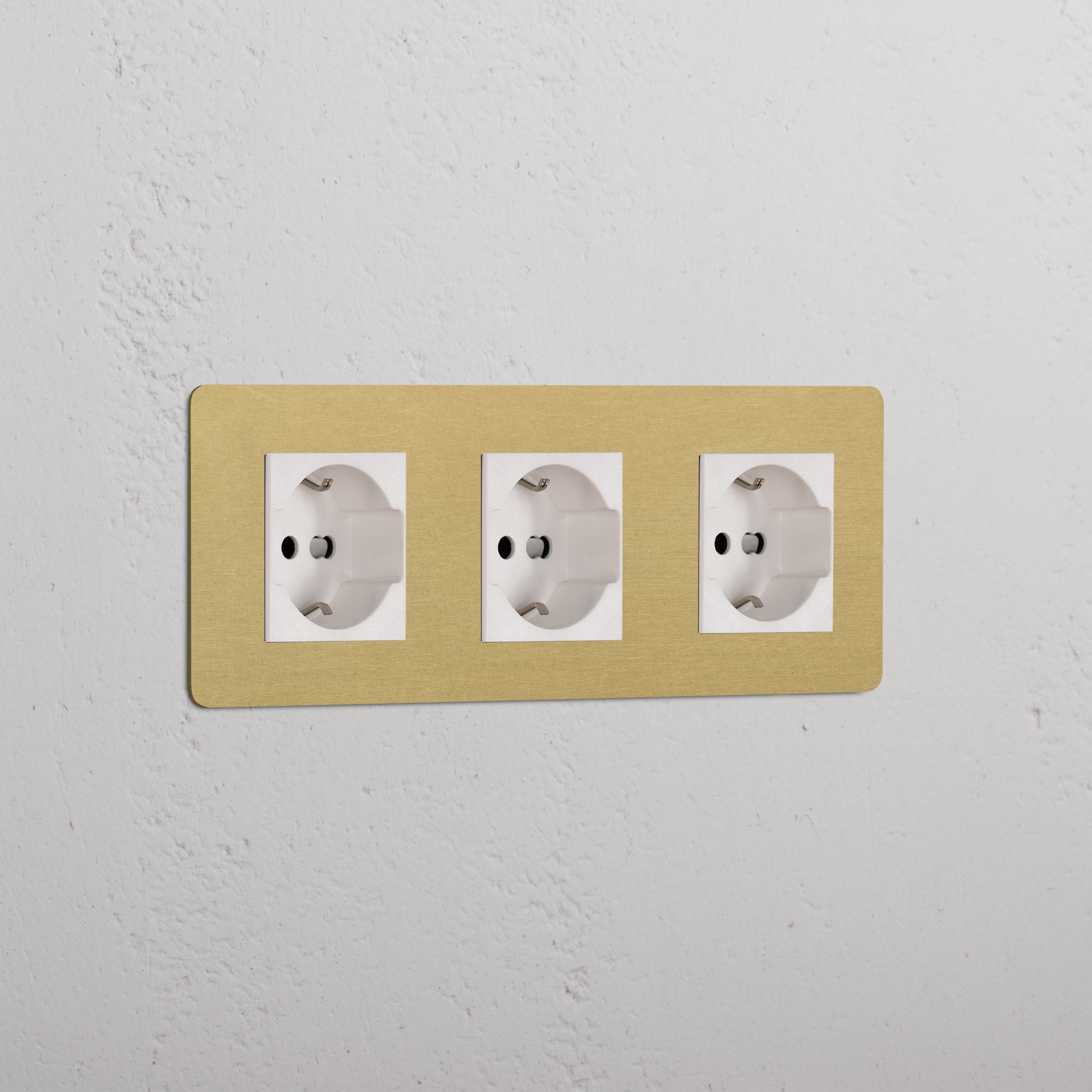 Triple 3x Schuko/Bipasso Module in antique brass white with three electrical sockets on a beige panel.