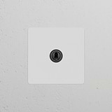 Single Toggle Switch (Ret) – Paintable Bronze on a white wall; suitable for single switches and dimmers.