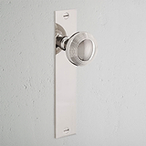 Poplar Long Plate Sprung Door Knob Polished Nickel Finish on White Background at an Angle