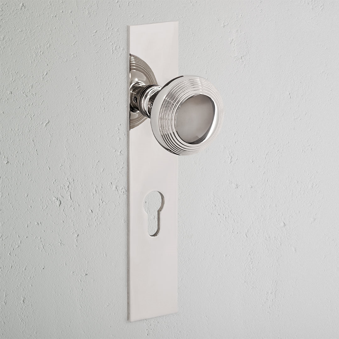 Poplar Long Plate Sprung Door Knob & Euro Lock Polished Nickel Finish on White Background 