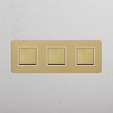 Smooth Operation with Triple Rocker Switch in Antique Brass White Design on White Background