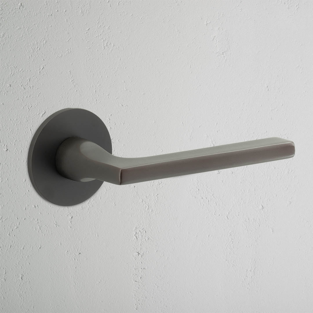 Clayton Flush Rose Sprung Door Handle Bronze Finish on White Background 