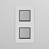 Double 2x vertical rocker switch in polished nickel and black, paintable for customization.