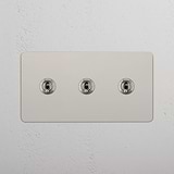 Versatile Triple Control Light Switch: Triple Toggle Switch in Polished Nickel on White Background