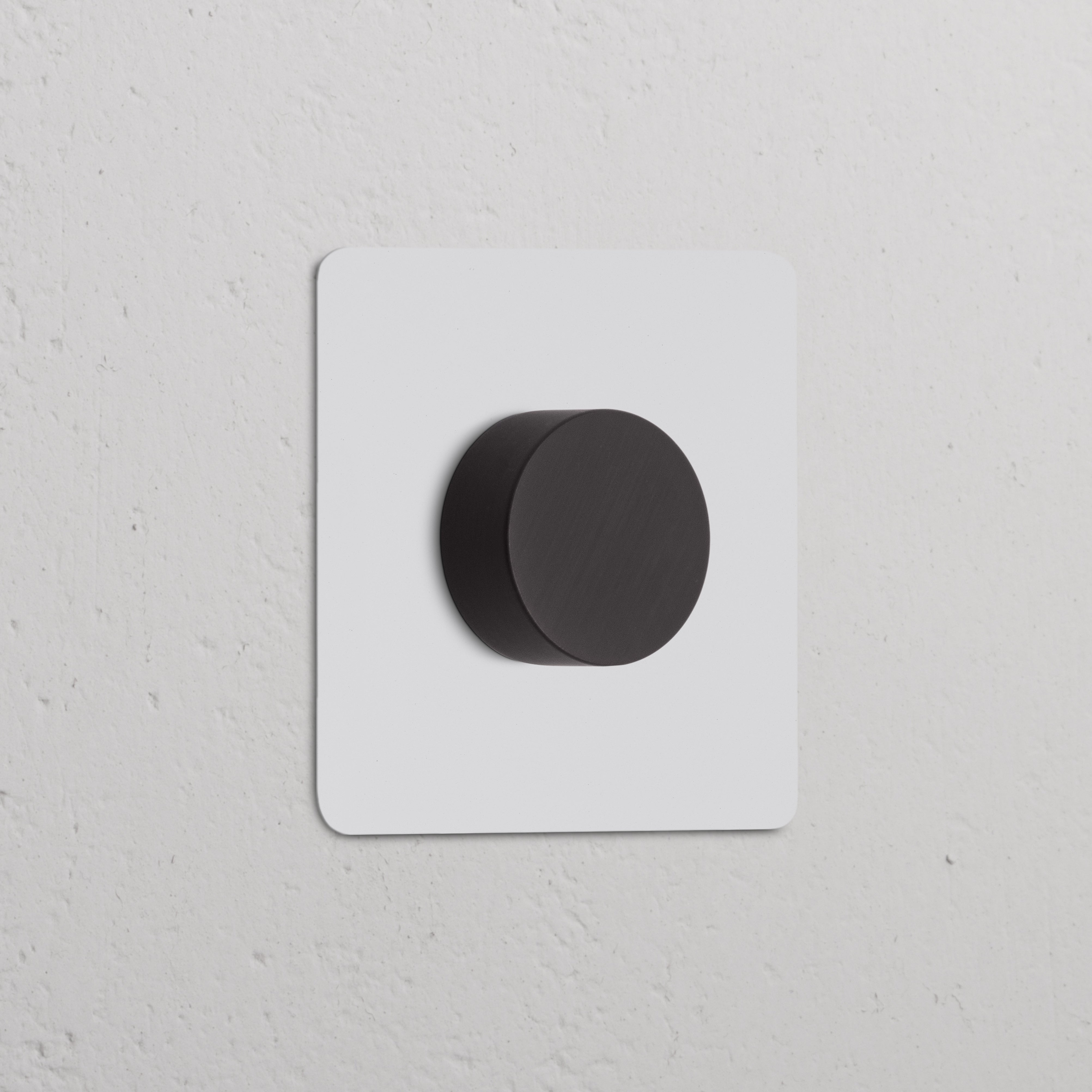 Paintable bronze square wall plate with a black round knob, designed as a single dimmer switch.