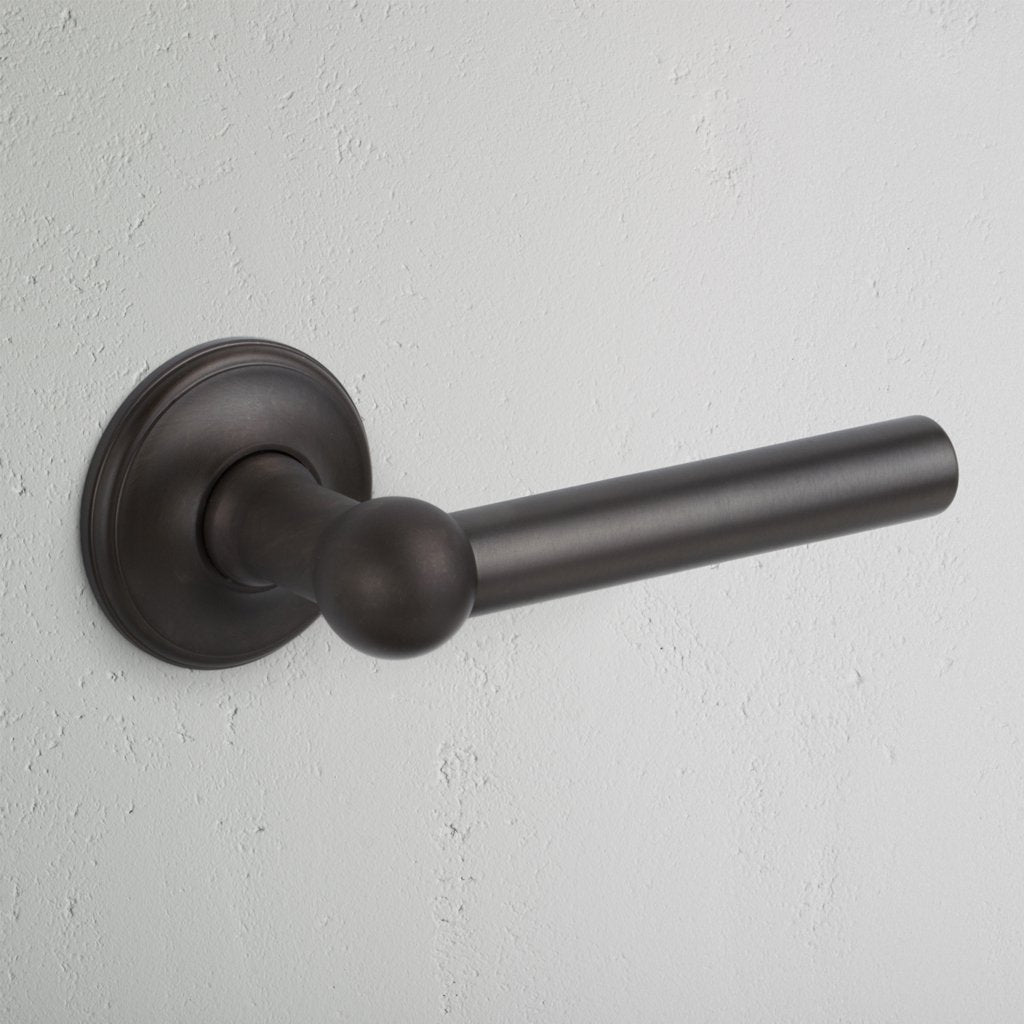 Bronze Harper Sprung Door Handle on White Background