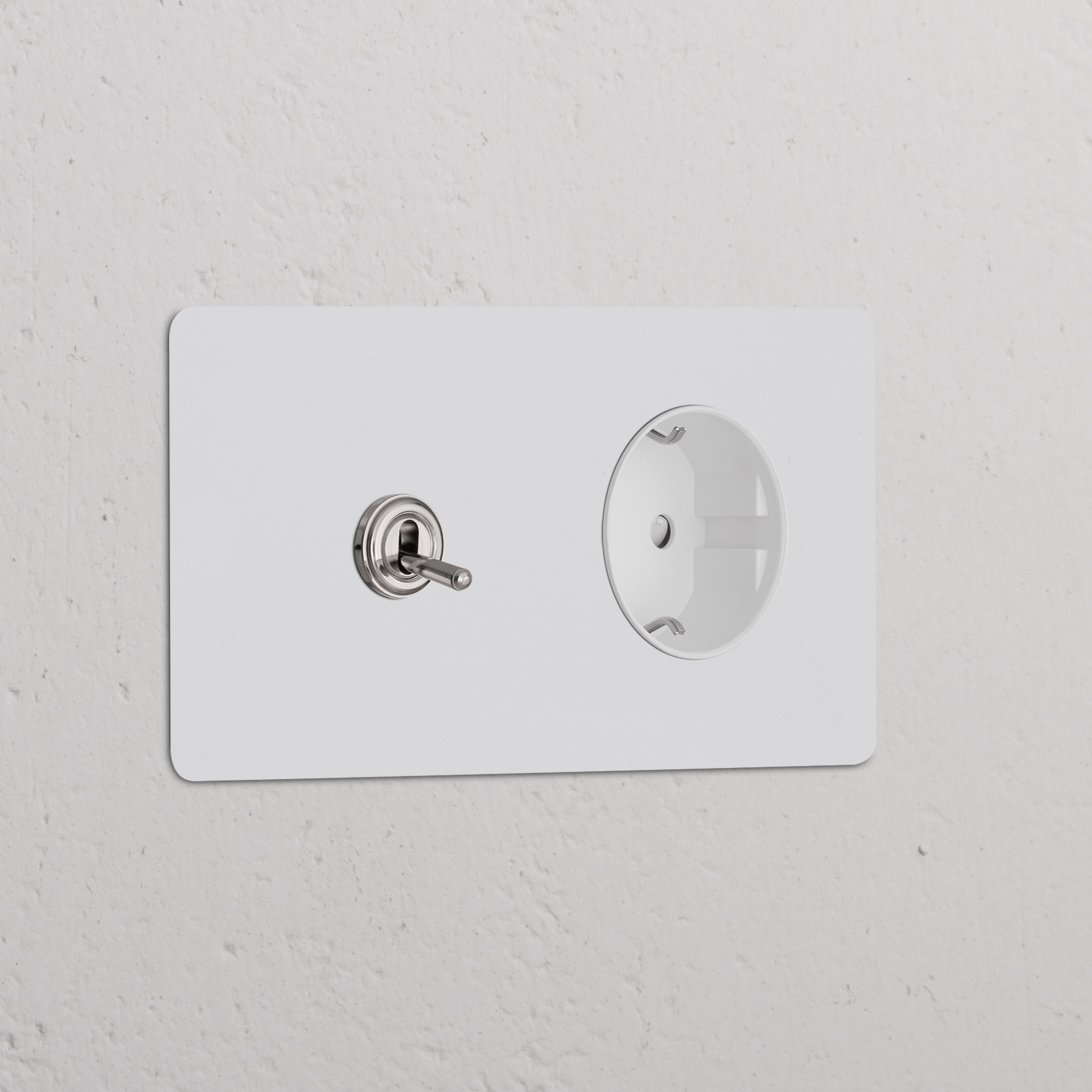 Double Toggle Switch + Schuko Type F Power Module in White Paintable Polished Nickel on a sleek white wall.