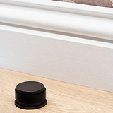 Bronze Seymour Door Stop on Wooden Floor