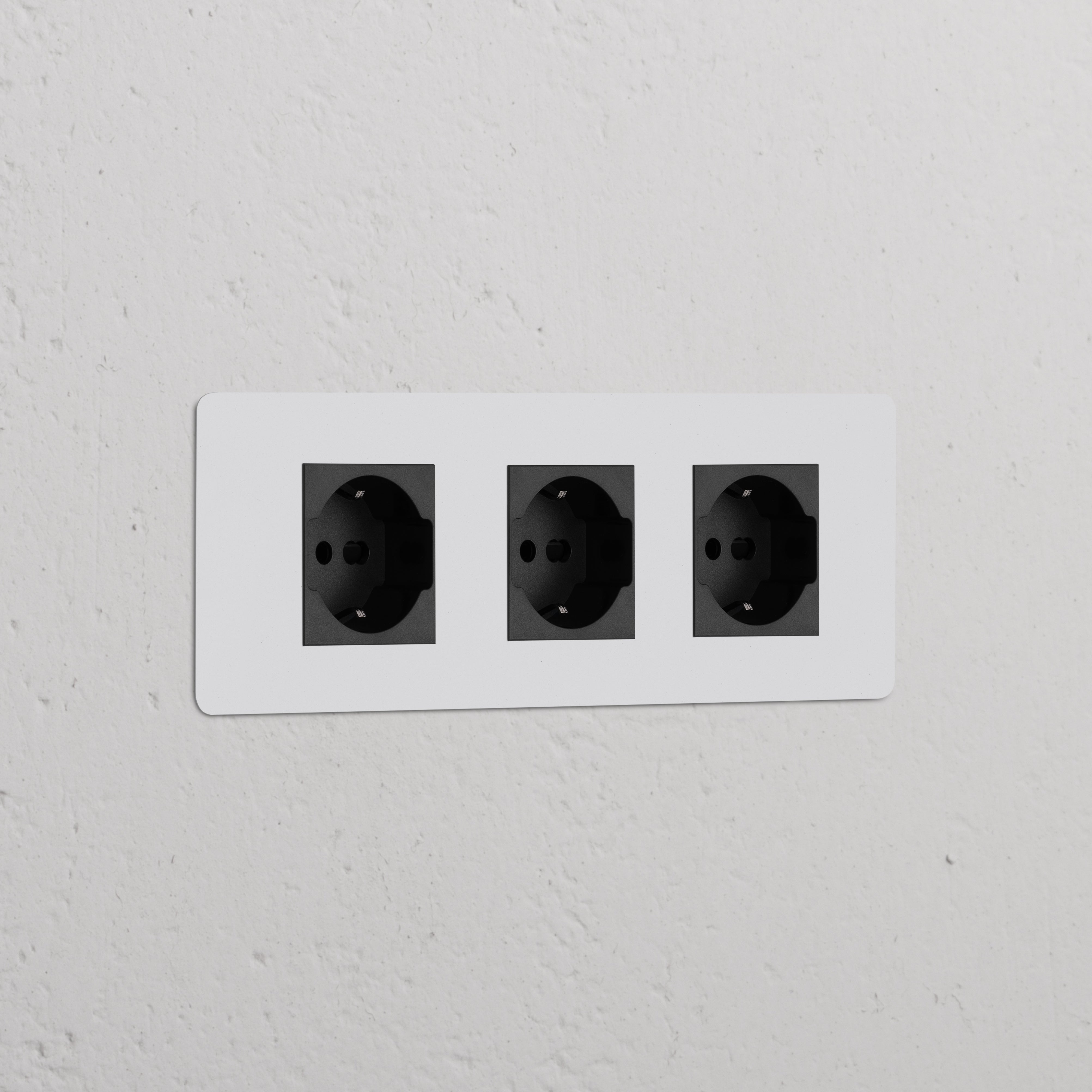 Triple 3x Schuko/Bipasso Power Module with three paintable black sockets integrated into a wall.