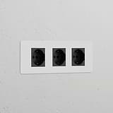 Triple 3x Schuko/Bipasso Power Module with three paintable black sockets integrated into a wall.