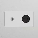 Double Toggle Switch and Danish Type K Power Module in polished nickel black on a white textured wall.
