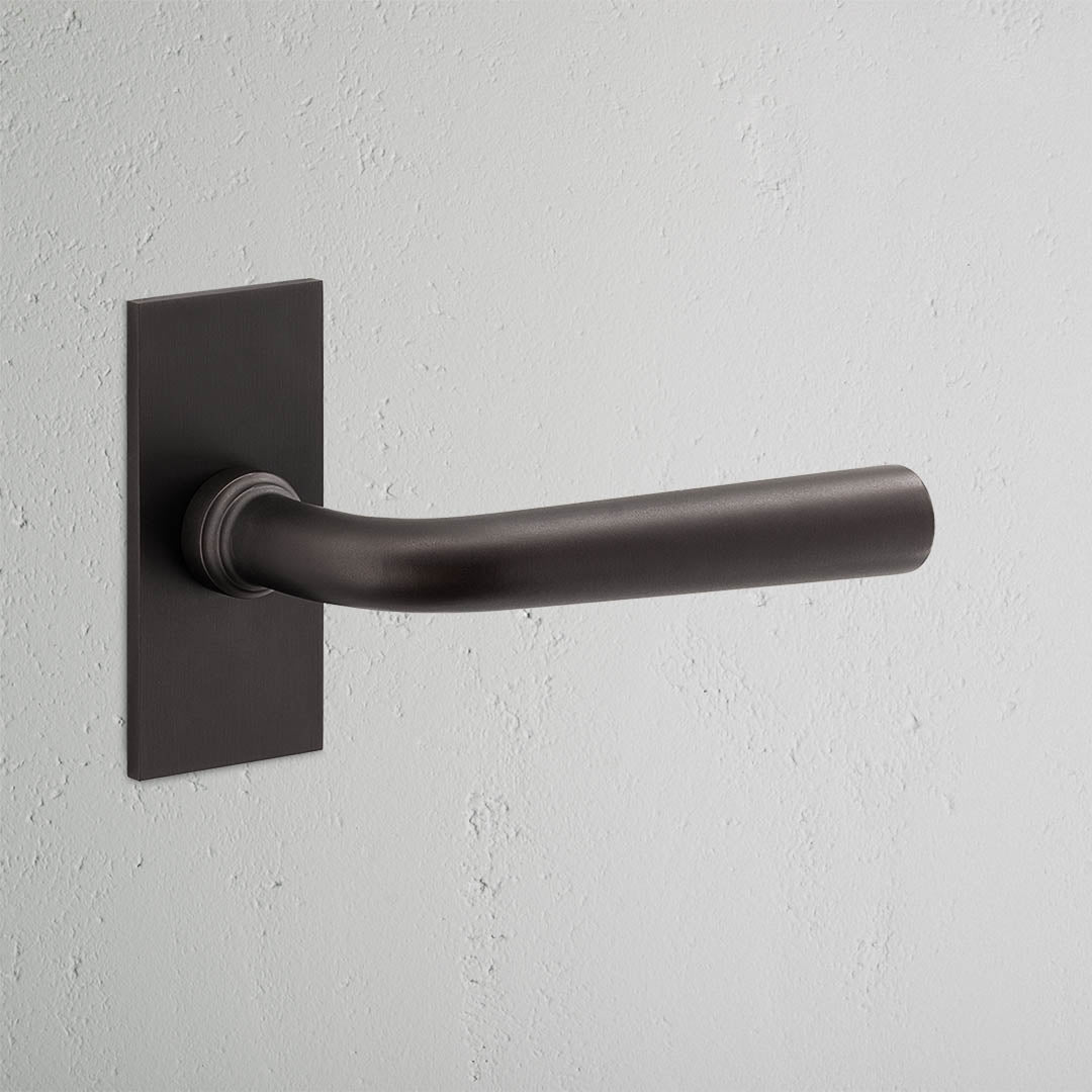 Apsley Short Plate Fixed Door Handle Bronze Finish on White Background