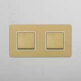 Two Position Double Rocker Switch in Antique Brass White on White Background
