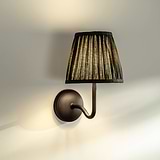 Medium Malvern Wall light in Deep Green at an angle affixed to a wall and turned on