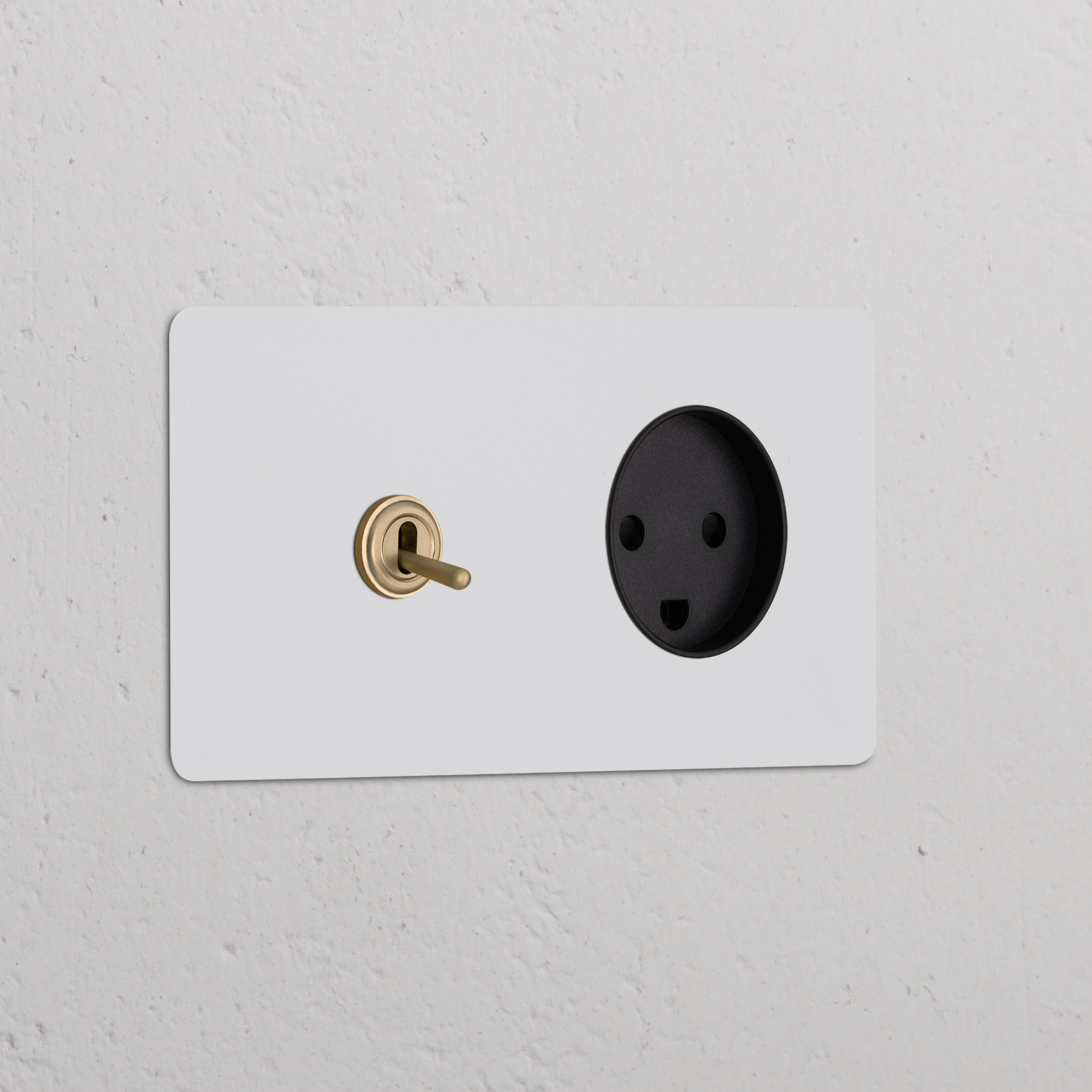 Double toggle switch + Danish Type K power module in paintable antique brass black on white textured wall.