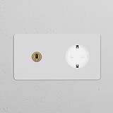 Double toggle switch with Schuko Type F power module in paintable antique brass white finish on a textured wall.