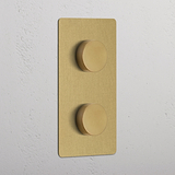 Antique Brass Double 2x Vertical Multiway Dimmer Switch with two round knobs on a white wall.
