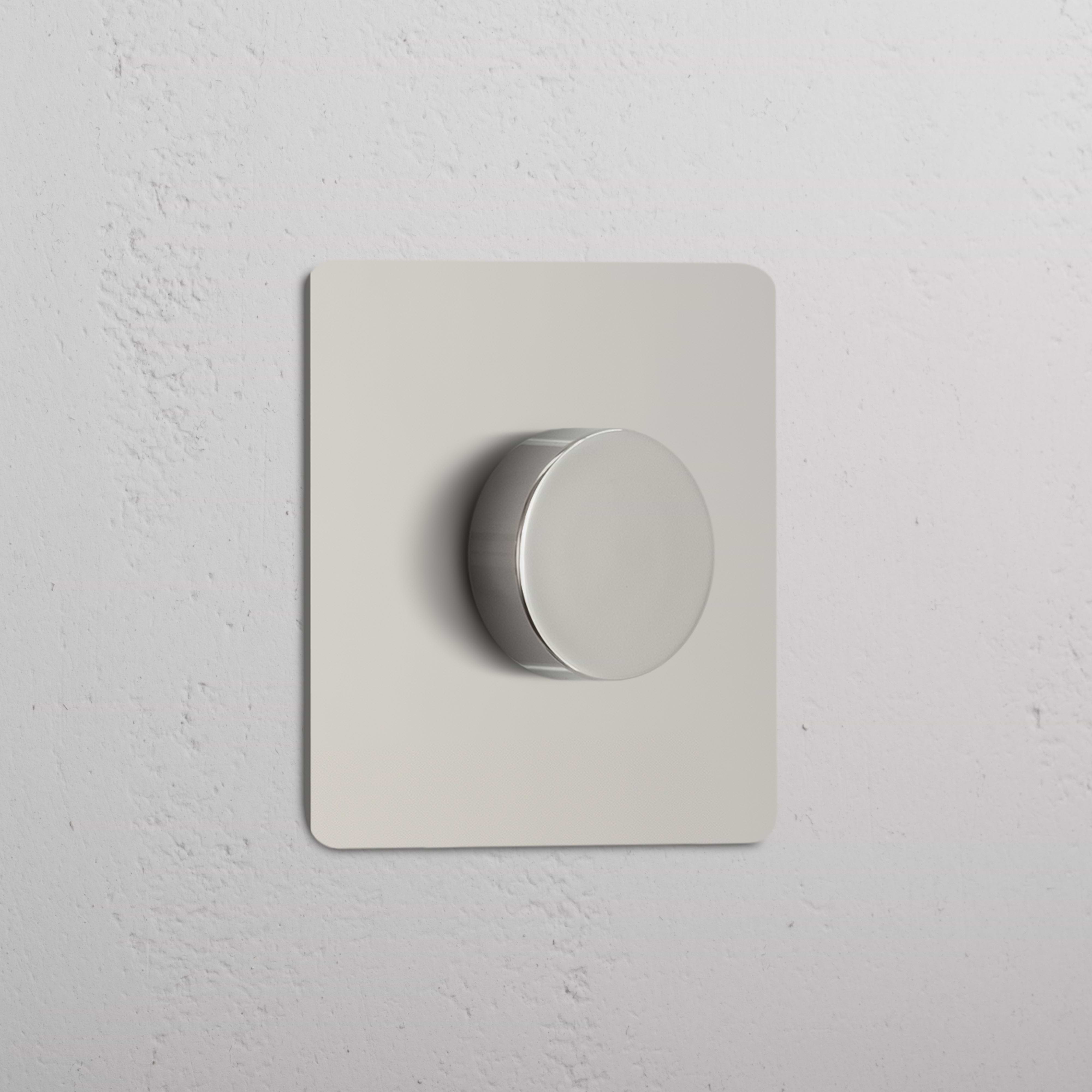Single Multiway Dimmer Switch in polished nickel with round knob, mounted on a white textured wall.