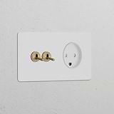 Paintable antique brass double toggle switch and Danish Type K power module on a white wall.