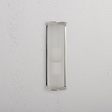 Medium wall light featuring fluted glass shade and polished nickel finish, mounted on a white wall.
