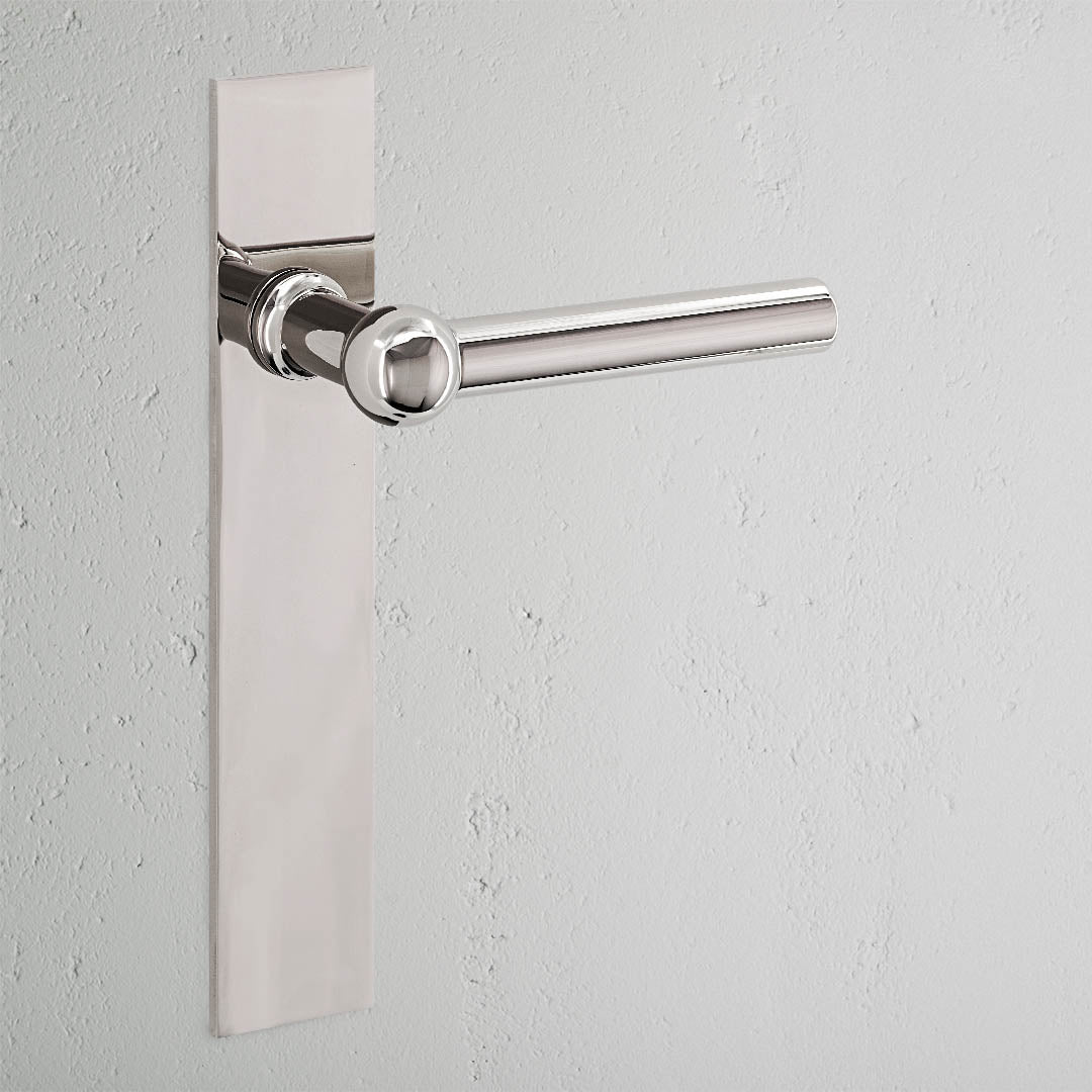 Harper Long Plate Sprung Door Handle Polished Nickel Finish on White Background