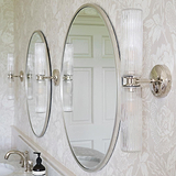 Claremont Medium Wall Light Fluted Glass Antique Brass Finish alongside a silver framed mirror above a bathroom sink