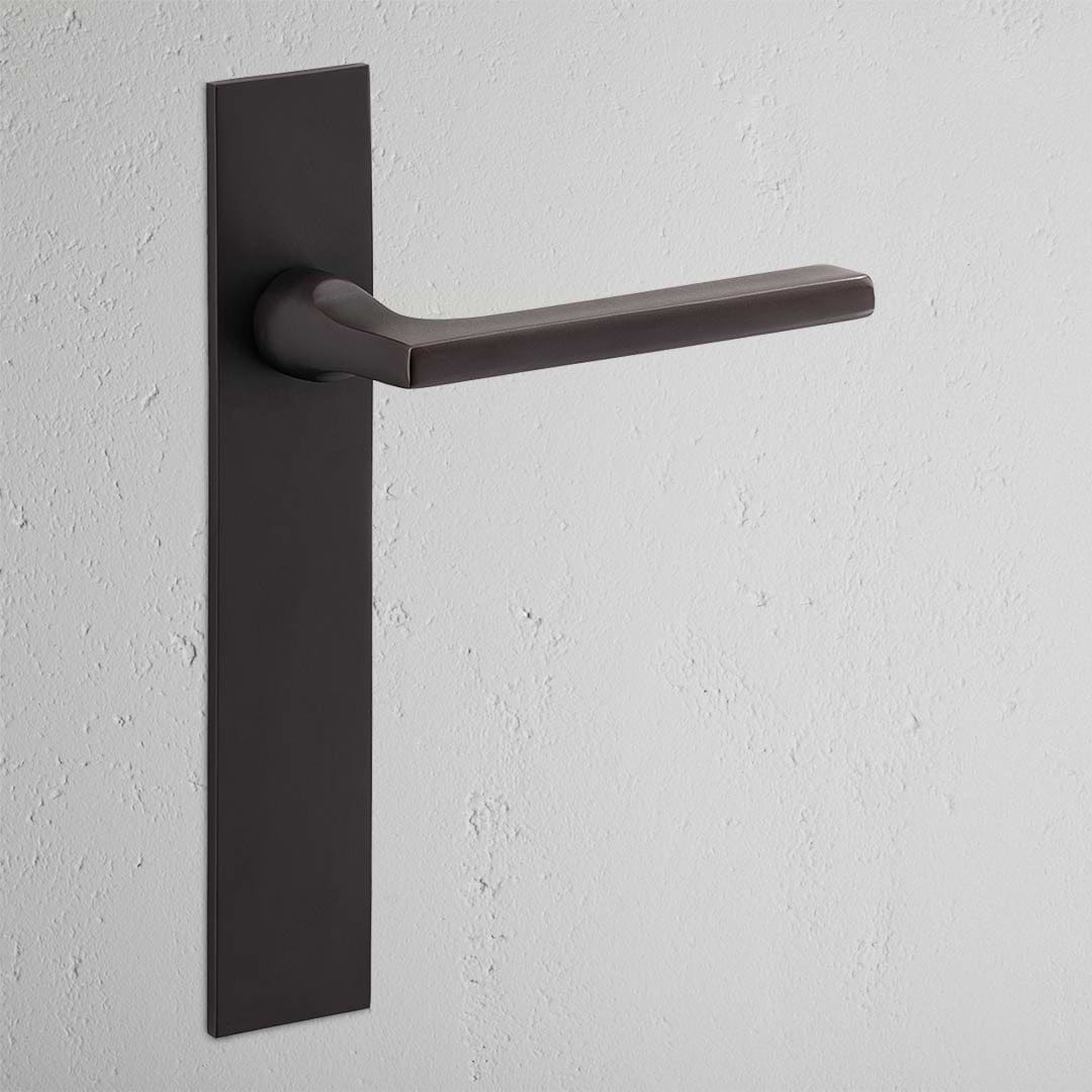 Clayton Long Plate Sprung Door Handle Bronze Finish on White Background