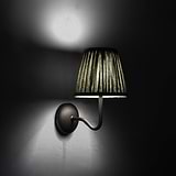Medium Malvern Wall light in Deep Green at an angle and turned on at night