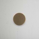 Onslow Sprung Door Knob Antique Brass Finish on White Background Front Facing