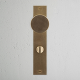 Onslow Long Plate Sprung Door Knob & Thumbturn Antique Brass Finish on White Background right Facing Front View