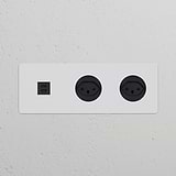 Black power module with two Swiss Type J sockets and triple USB 30W ports for versatile connectivity.