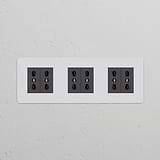 Triple 6x Bipasso Power Module in paintable black, featuring three sockets for versatile connectivity in any décor.
