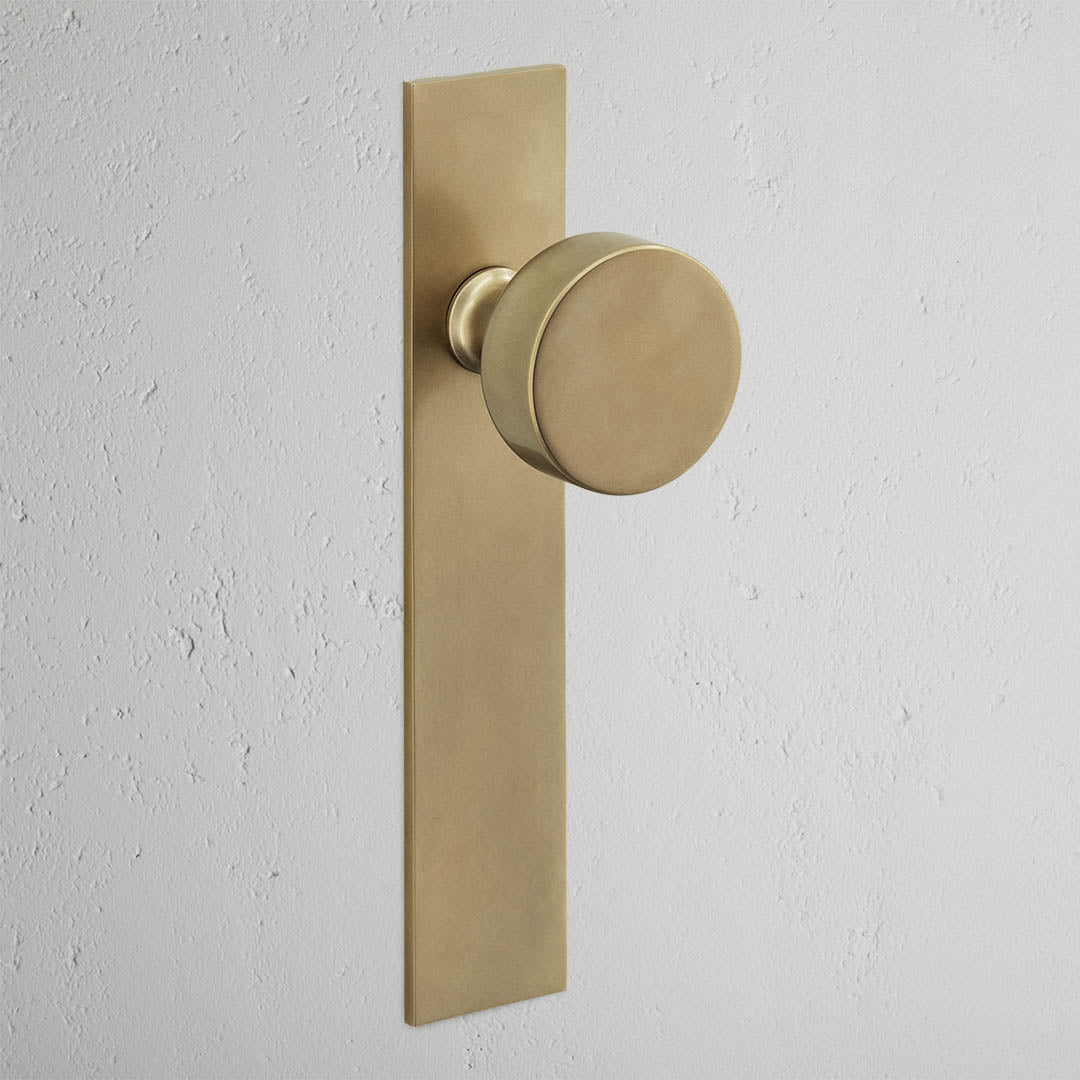 Onslow Long Plate Sprung Door Knob - Antique Brass