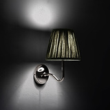 Medium Malvern Wall light in Deep Green at an angle and turned on at night