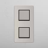 Dual Vertical Light Control Switch on White Background: Polished Nickel Black Double 2x Vertical Rocker Switch