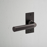 Apsley Short Plate Fixed Door Handle Bronze Finish on White Background at an Angle