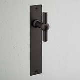 Harper T-Bar Long Plate Sprung Door Handle Bronze Finish on White Background at an Angle