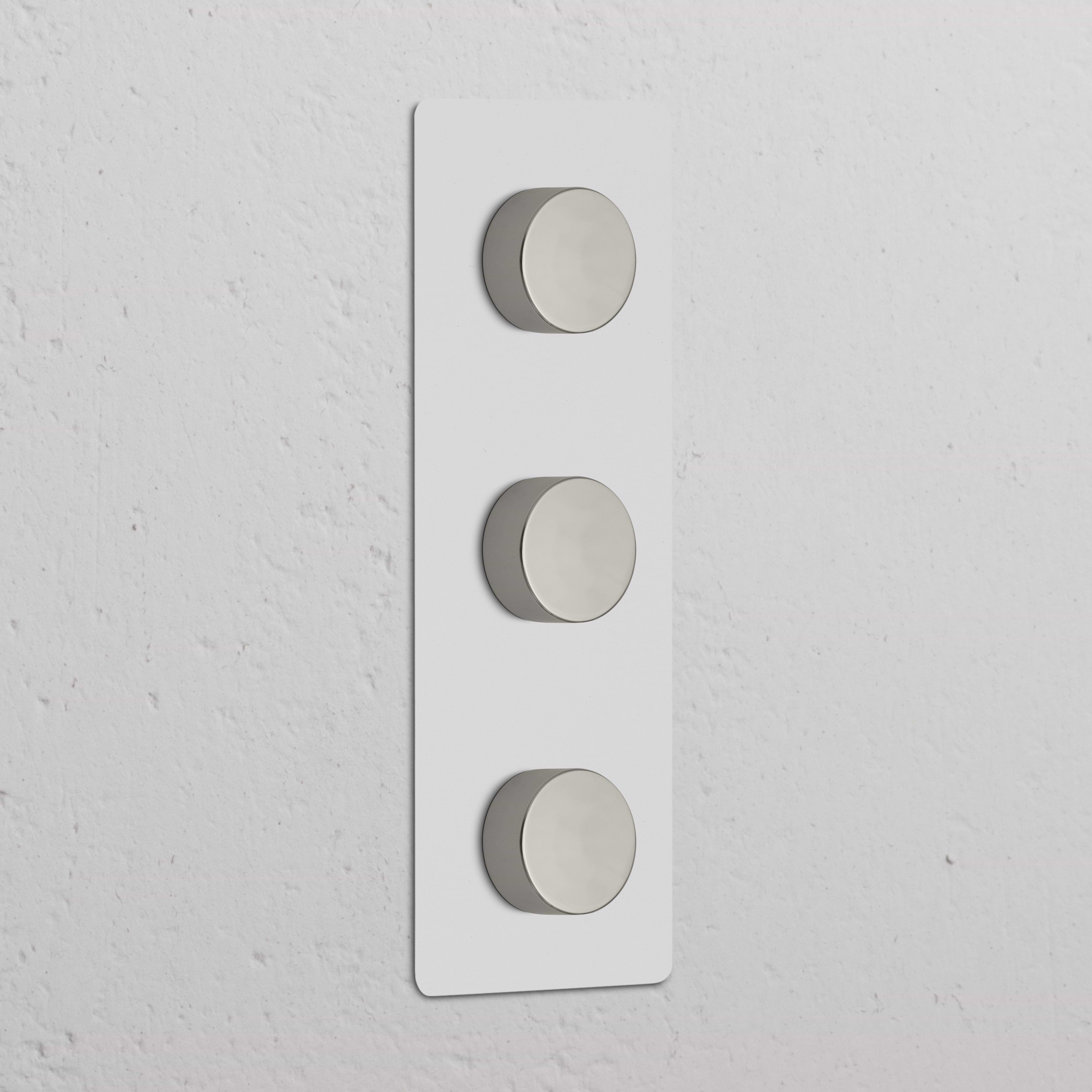 Triple 3x Vertical Multiway Dimmer Switch in paintable polished nickel with three round knobs on a white plate.