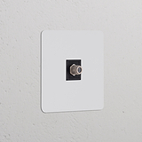 Paintable black single satellite module with a coaxial connector, ideal for integrated socket installations.