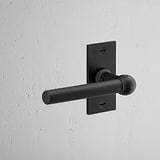 Harper Short Plate Fixed Door Handle Bronze Finish on White Background at an Angle