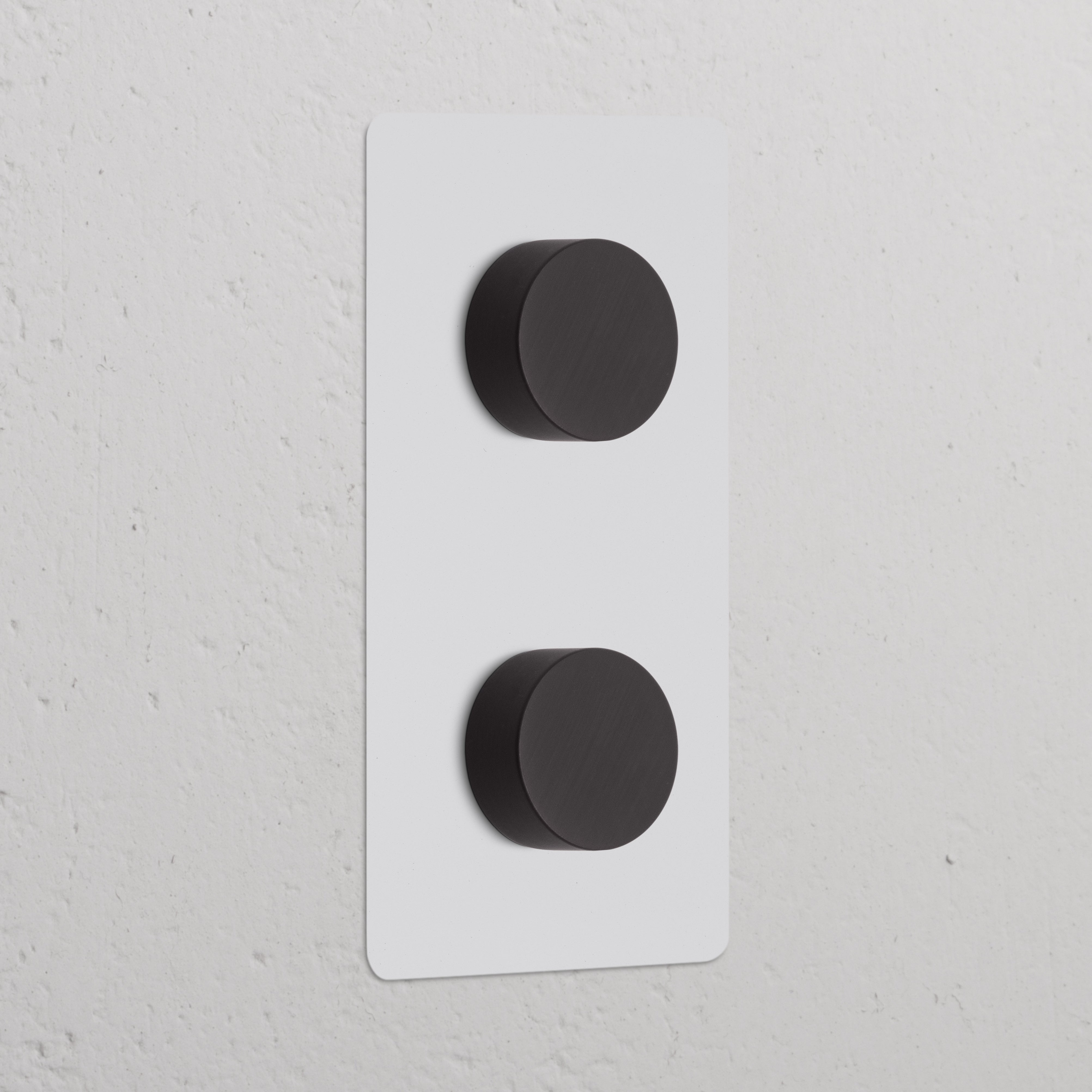 Double 2x vertical dimmer switch with paintable bronze finish and two black knobs for adjustable lighting.