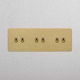 Antique Brass Triple Toggle Switch Designed with Six Levers on White Background