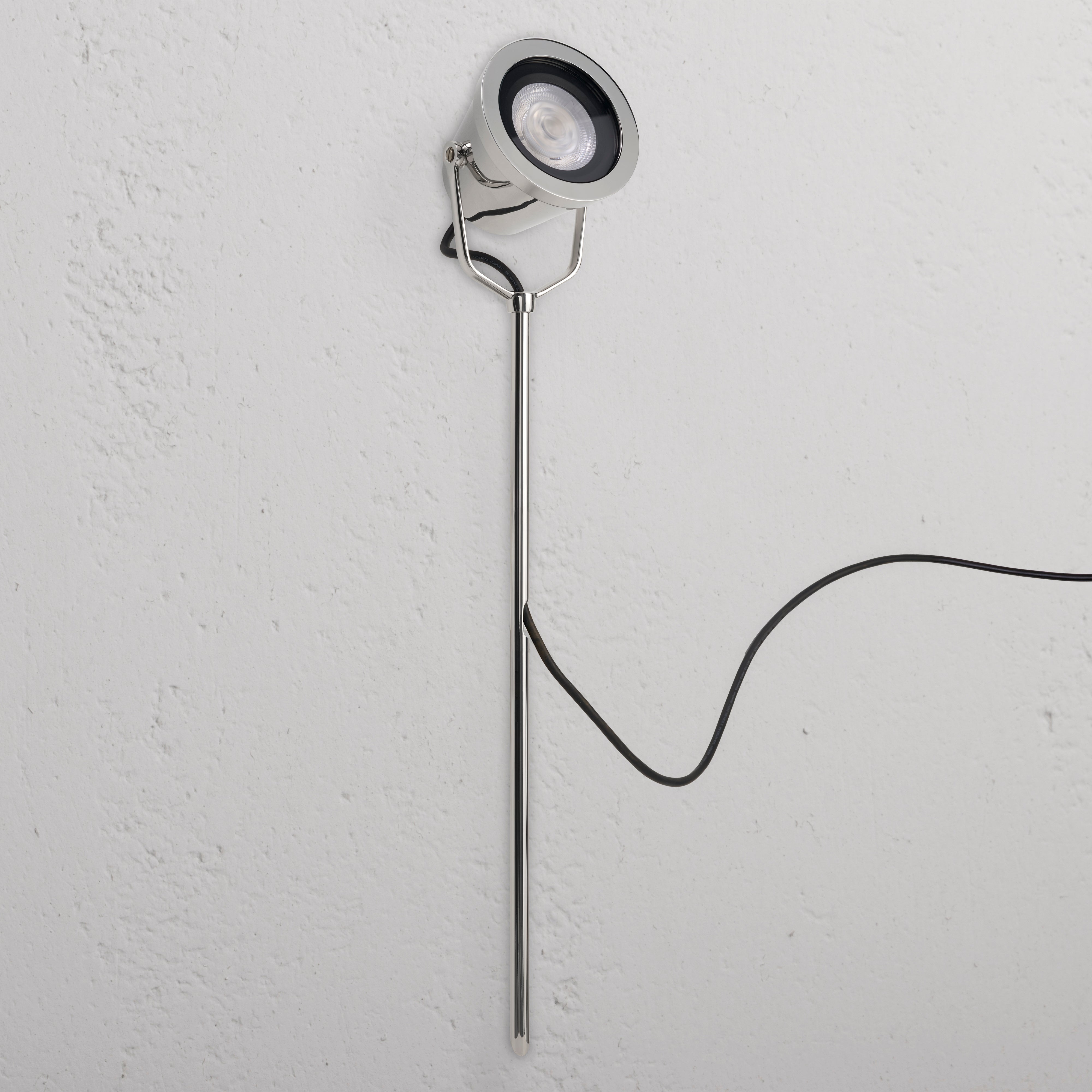 Cambridge Ground Floodlight in polished nickel, outdoor design with sleek stand and visible black power cord.